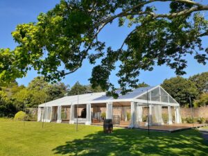 Part Clear Hocker Marquee on Property with Timber Flooring for Wedding