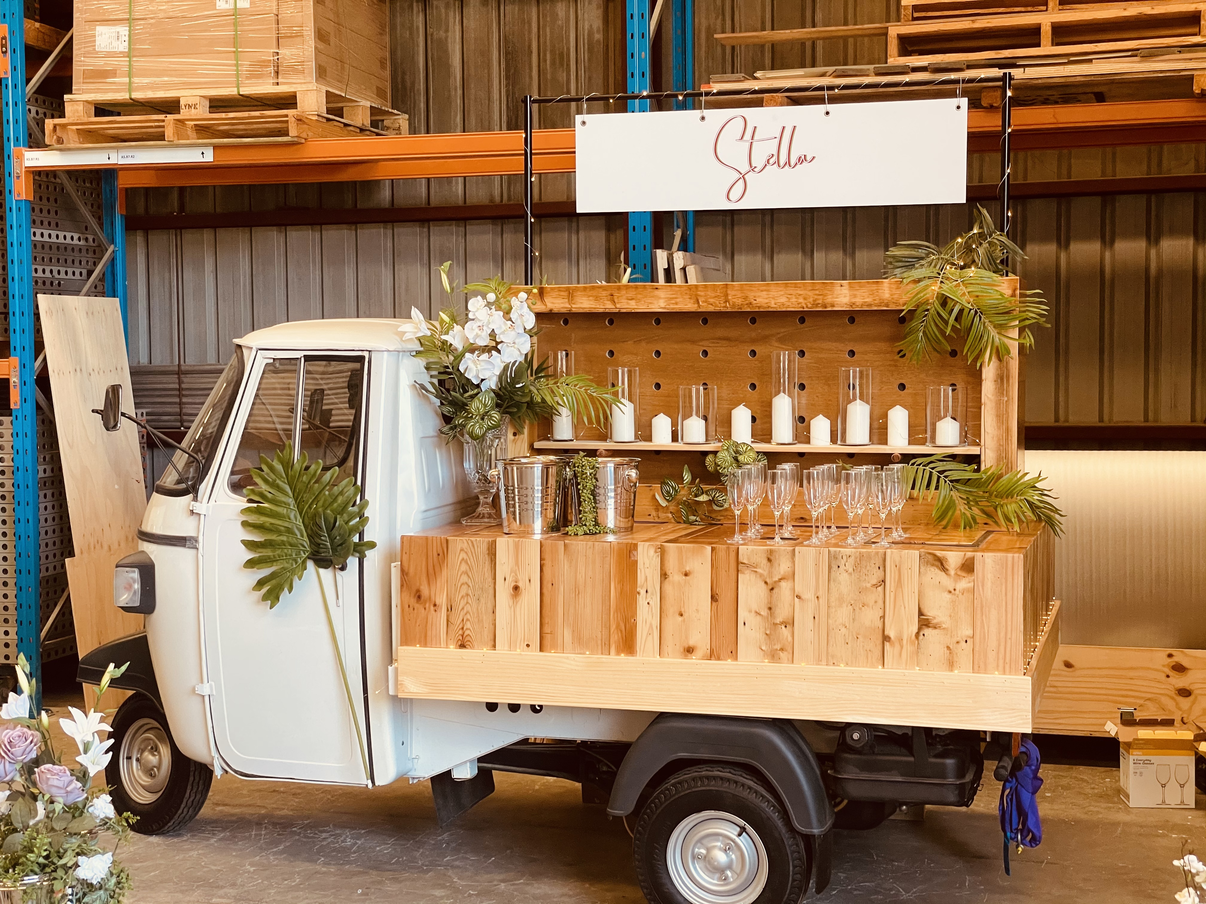 Stella the Piaggio Ape Hospitality Vehicle with Custom Signage and Decor.