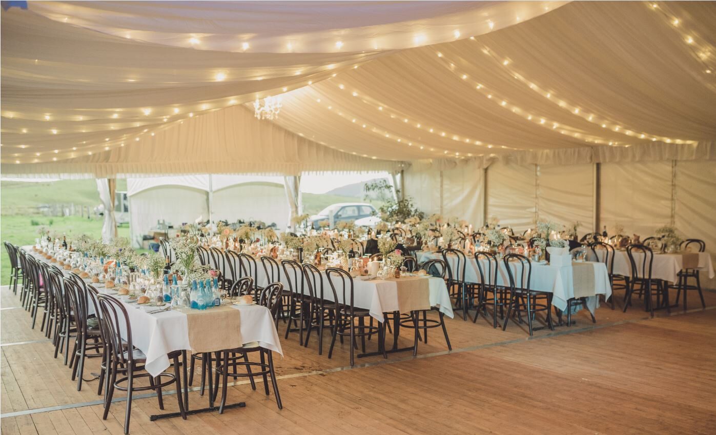 Interior long banquet tables and bentwood chairs