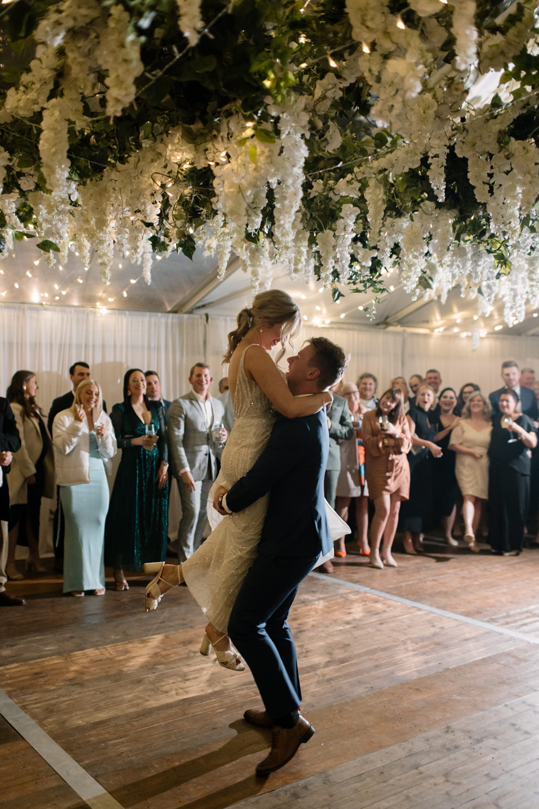 Bride and Groom's First Dance under Hocker Marquee with Hanging Florals on Integrated Dancefloor