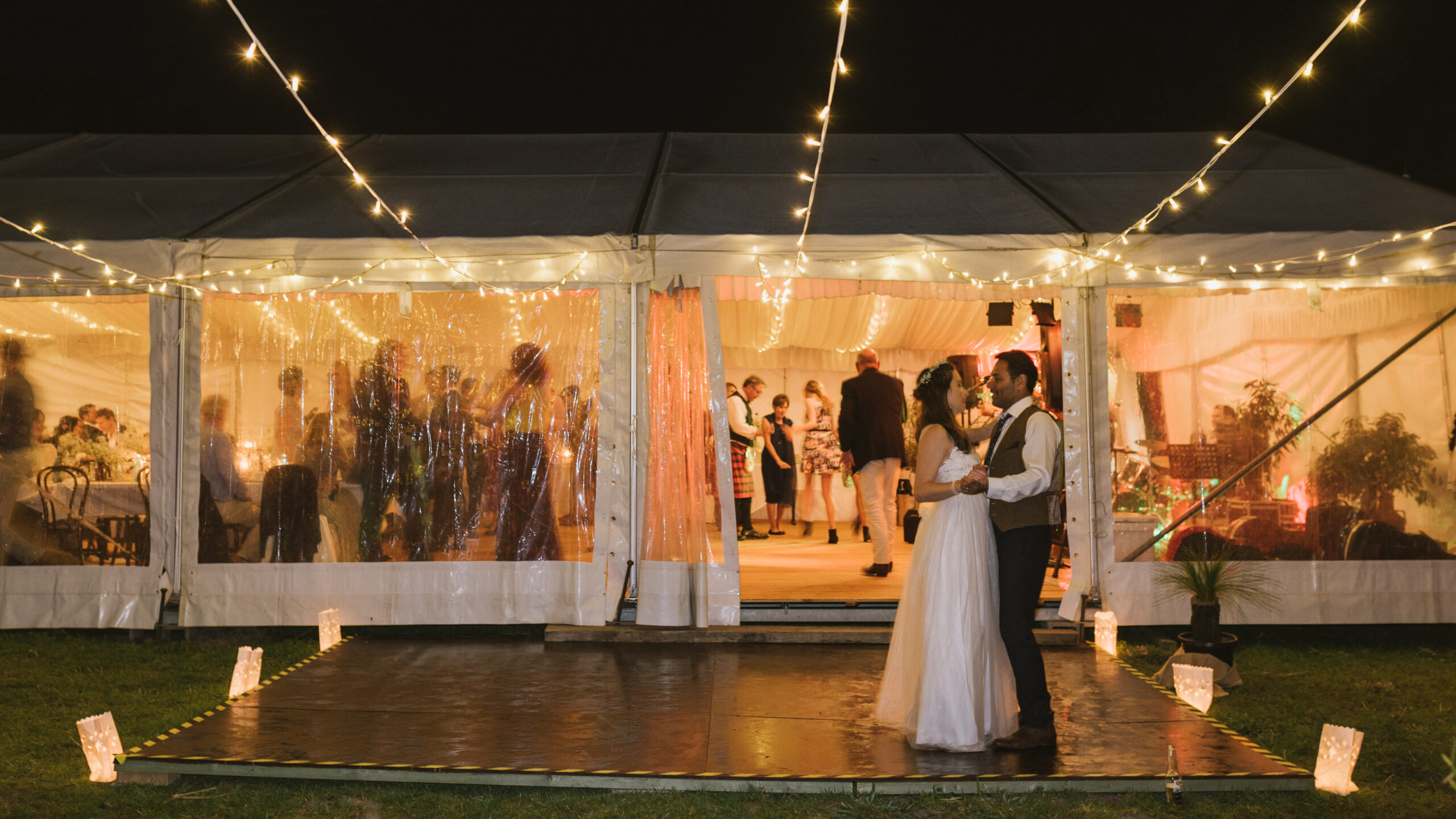 Clear Hocker Marquee With Fairy Lights on Property with Timber Flooring for Wedding Reception