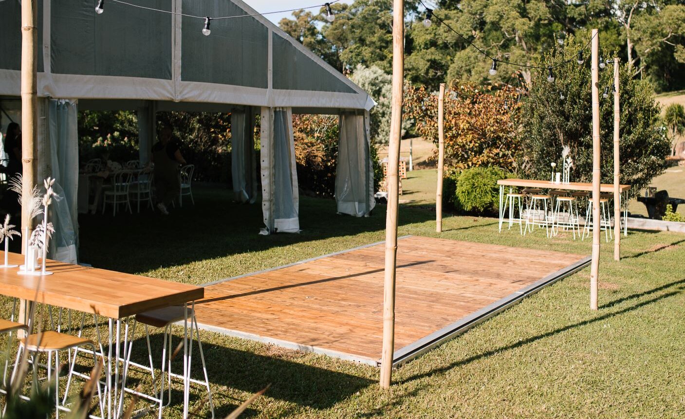 Outside Hire Dance floor for Wedding Reception with Festoon Lighting and High Bar Tables.