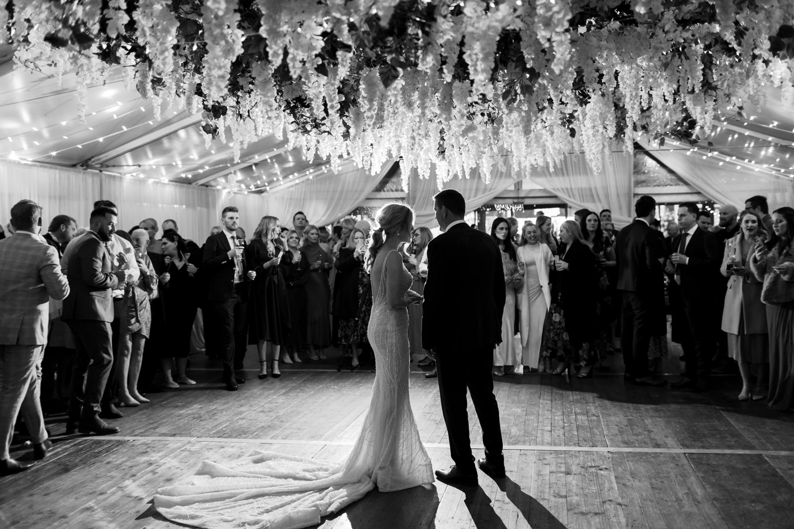 Bride and Groom's First Dance under Hocker Marquee with Hanging Florals on Integrated Dance floor