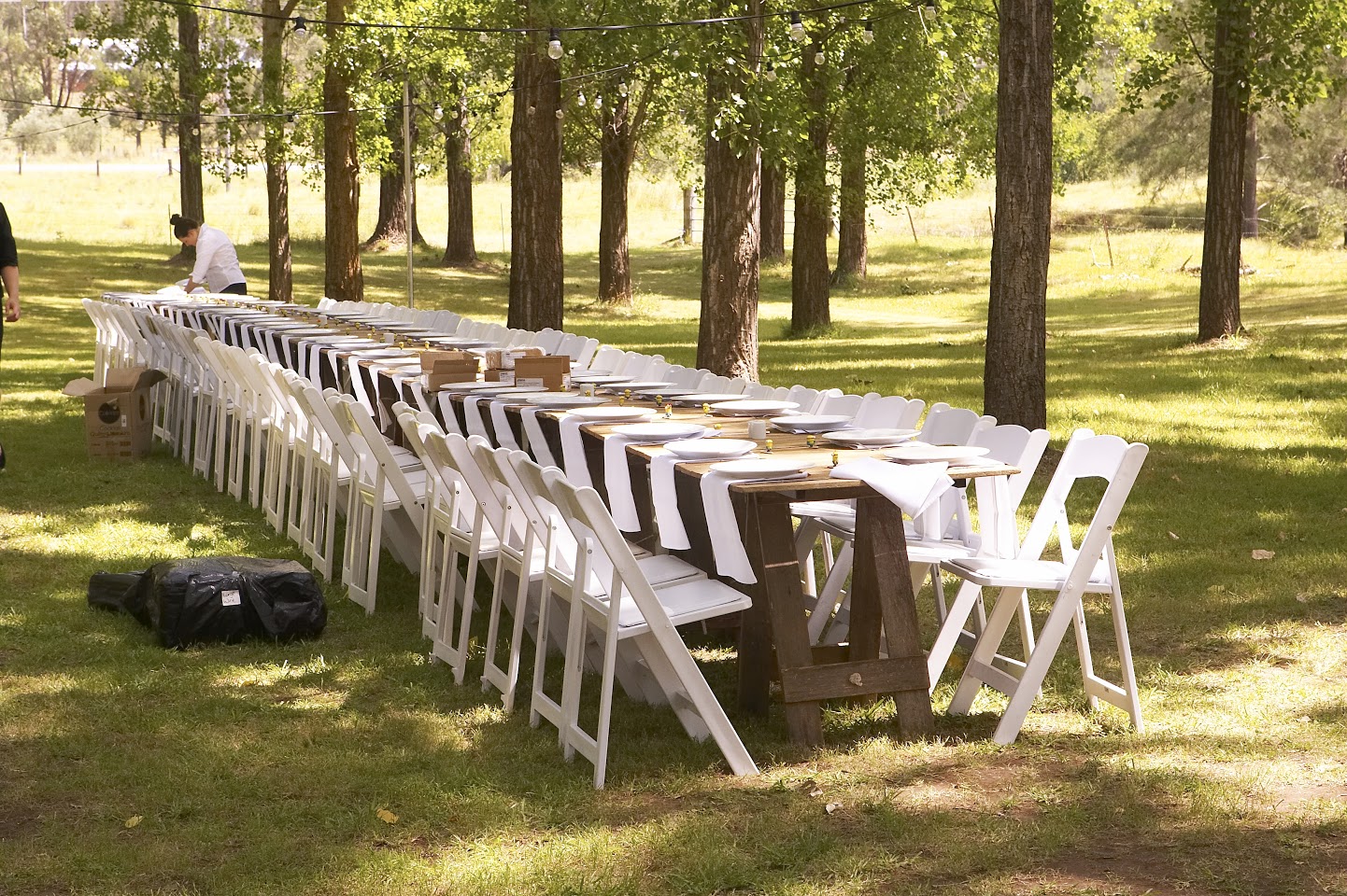 White Fold Up Chairs Outside with Timber Table