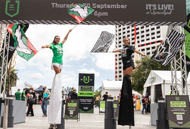 Ladies on stilts at NRL Fan Festival in Sydney with White Hocker Marquees
