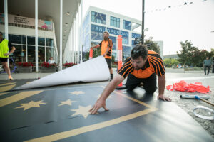 Applying Custom Graphic Ground Stickers at ANU Open Day