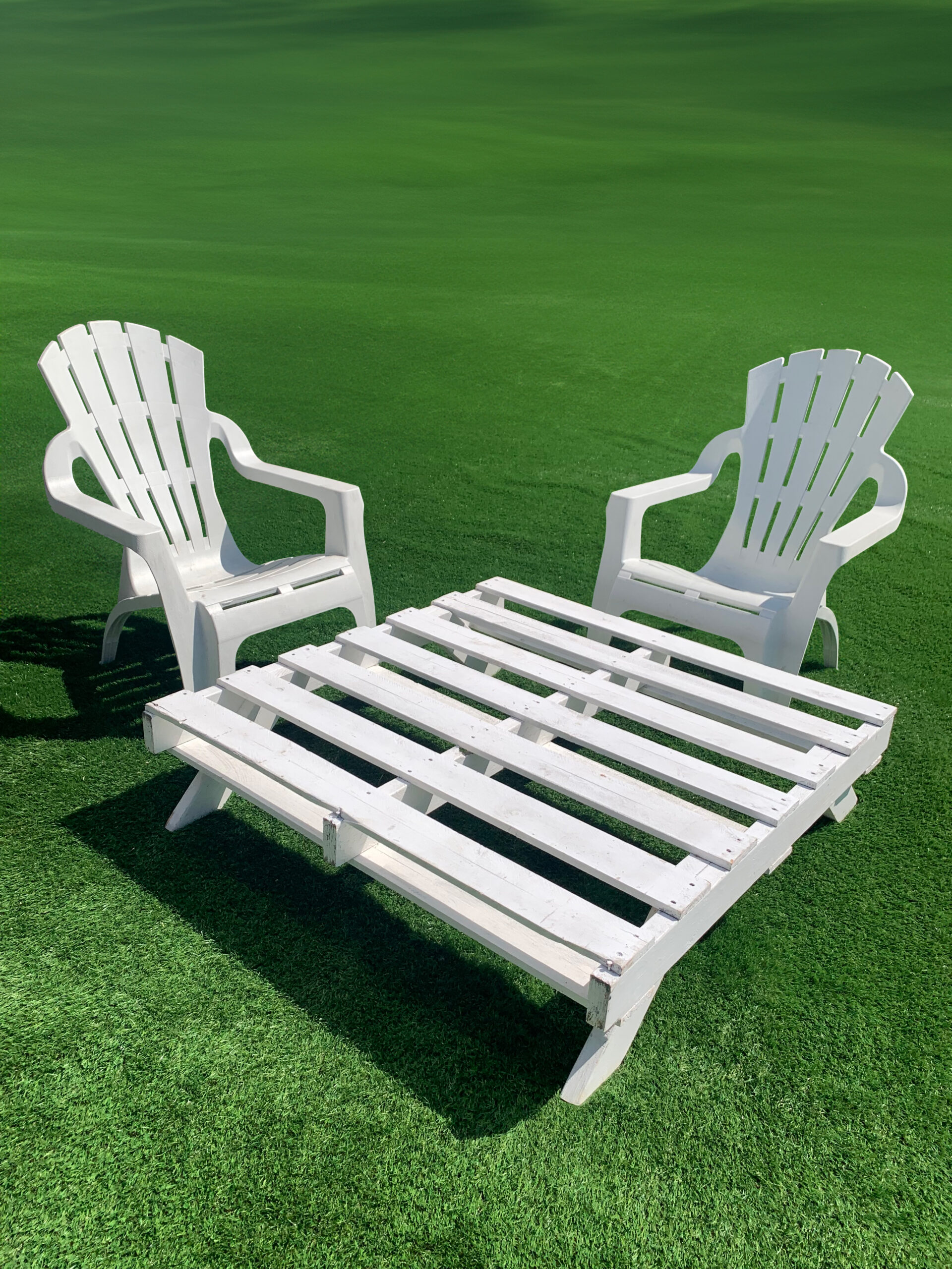 Pallet Picnic Table on grass styled with chairs for picnic setting