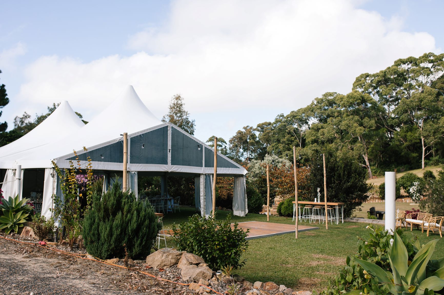 Terrigal wedding setup — clear marquee + festoon lighting.
